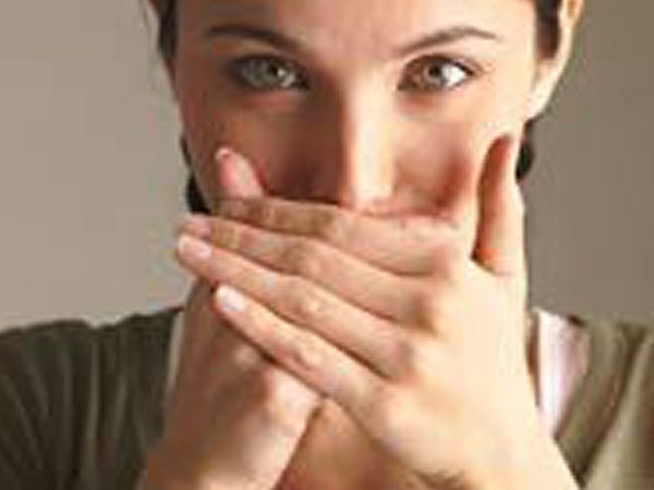 Woman covering mouth
