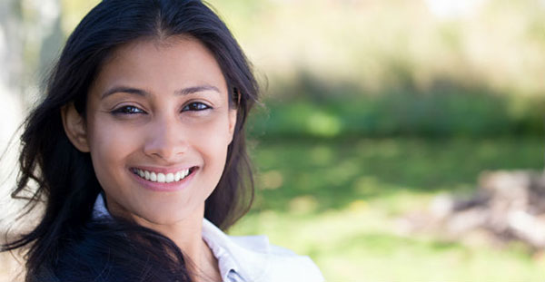 Woman smiling, wind blowing hair