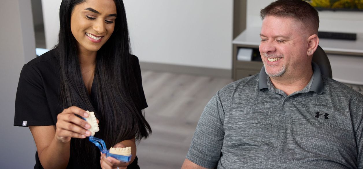 Doctor and patient discussing single tooth implants at CascadesONE