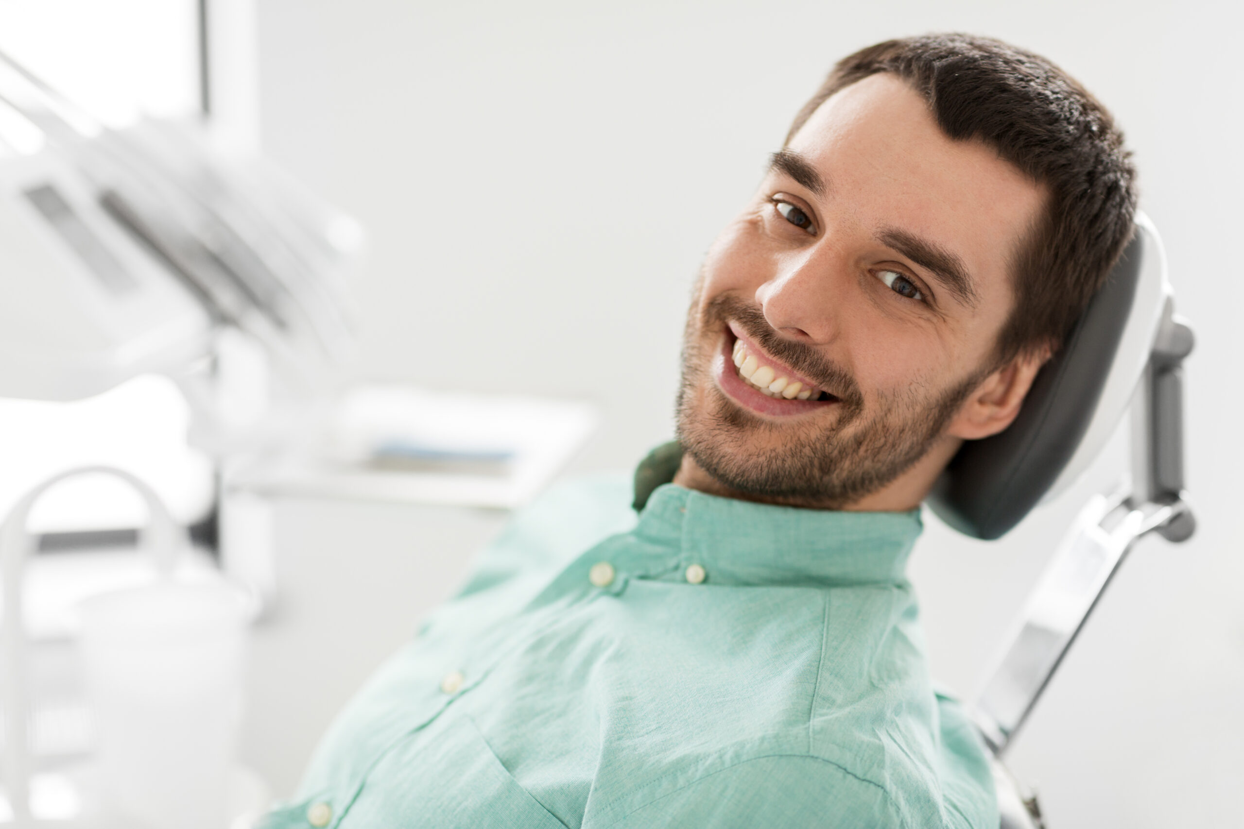 happy smiling male patient at dental clinic