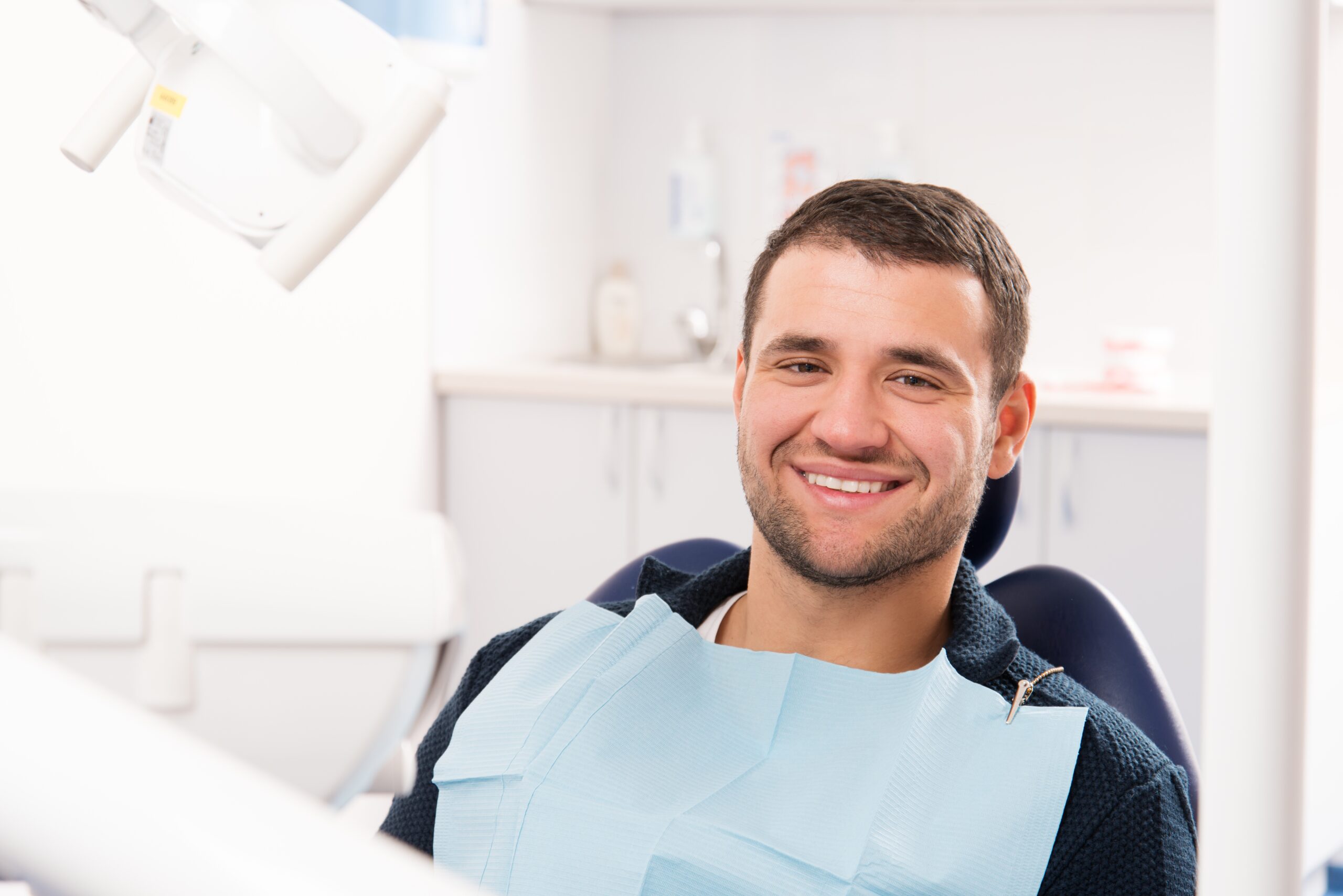 Smiling young man at dentist's surgery
